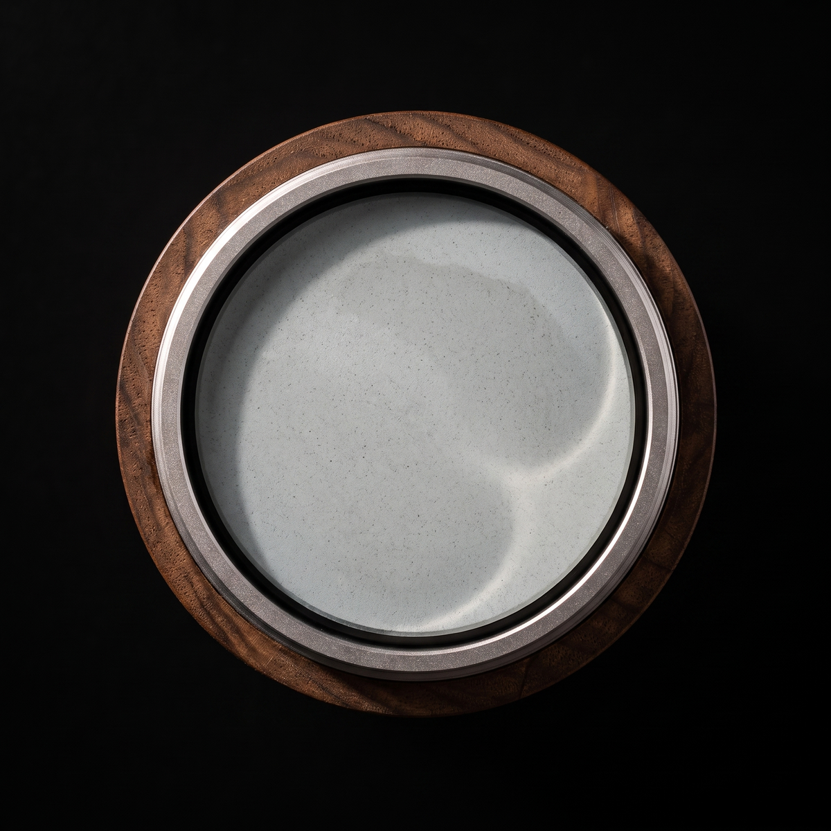 Top down view of the round water sharpening stone in its walnut holder