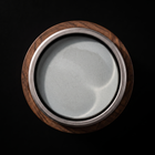 Top down view of the round water sharpening stone in its walnut holder